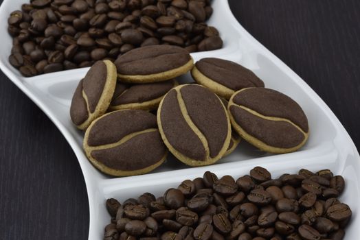 Delicious coffee cookies with coffee beans on a corrugated tray