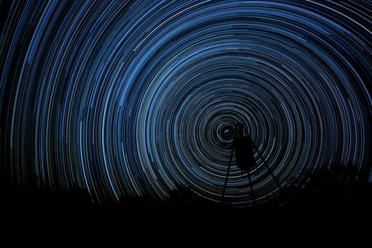 Long exposure of stars creating star trails (Stacked photos)