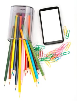 Fallen pencil cup with crayons and smartphone on isolated white background