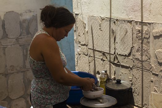 COLOMBIA, La Parada: Deported from Venezuela over a month ago, a Colombian woman, now living in a temporary shelter in the La Parada  area, near Cucuta, Colombia, is seen on September, 26, 2015, in her makeshift kitchen. Venezuelan President Nicolas Maduro announced on September 28, 2015 that he will let the deported Colombians return to Venezuela and legalize their status. In August,  President Maduro closed the borders with Colombia, in what he called a crackdown on smuggling and crime. 	