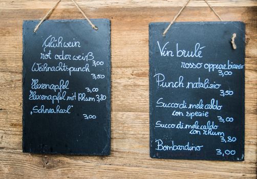 blackboards hanging on the wooden wall with a drink list