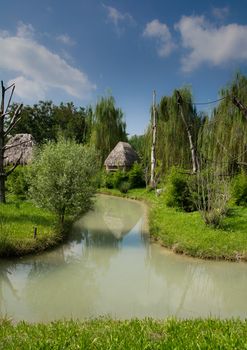 thatched hut on the river bank