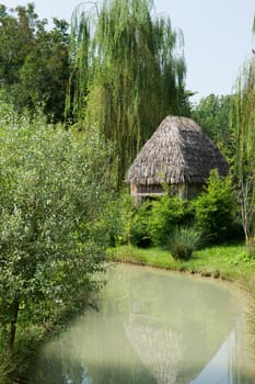 thatched hut on the river bank