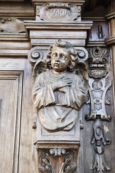 angel carved in a wood portal