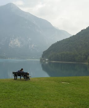 Lovers on a bench on the lake