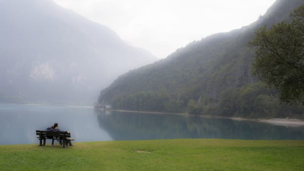 Lovers on a bench on the lake