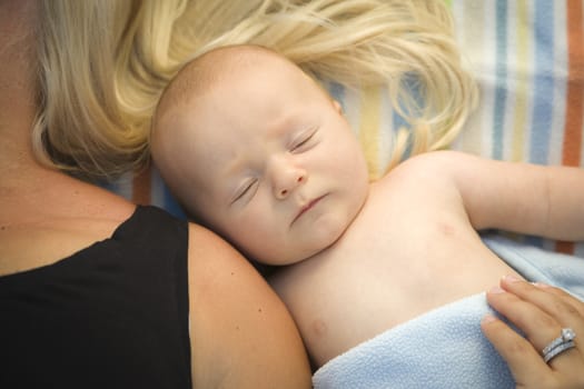 Cute Little Baby Boy Laying Next to His Mommy on Blanket.