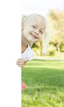 Cute Little Girl Outside Holding Edge of White Board with Room For Text.