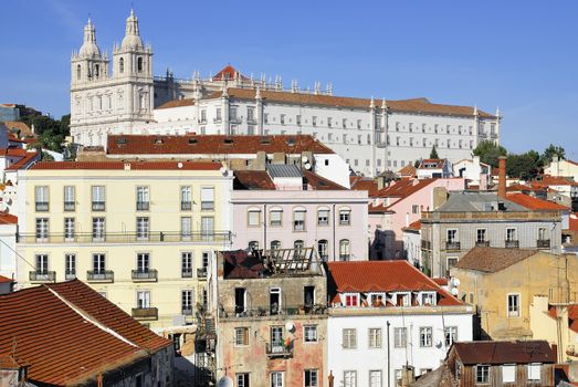 Panorama of old traditional city of Lisbon with red roofs and view of river Tagus.