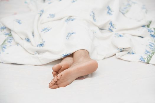 Feet of sleeping woman. Horizontal photo