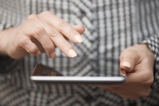 Hands of woman using digital tablet