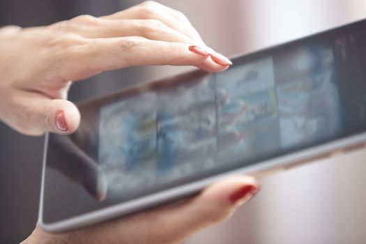 Hands of woman using digital tablet