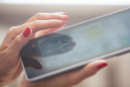 Hands of woman using digital tablet