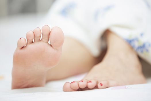 Feet of sleeping woman. Horizontal photo