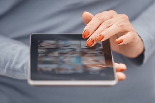 Hands of woman using digital tablet