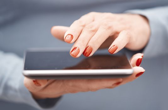 Hands of woman using digital tablet