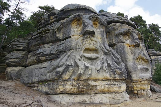 Heads of Devils are about 9 m high rock sculptures of giant heads carved into the sandstone cliffs in the pine forest above the village Zelizy in the district Melnik, Czech republic. It is the work of sculptor Vaclav Levy, who created in the period 1841-1846.