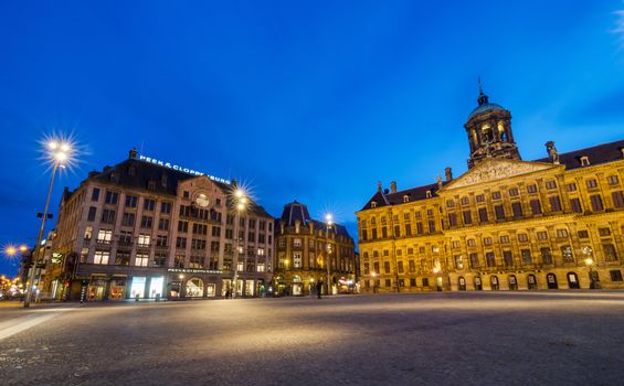 Amsterdam, Netherlands - May 7, 2015: Tourist visit Dam Square with a view of the Royal Palace and Madame Tussaud wax museum in Amsterdam, Netherlands. Its notable buildings and frequent events make it one of the most important locations in the country.