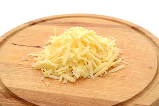 Grated cheese on a wooden chopping board