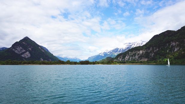 Scenery of Thun Lake and sail boat Interlaken, Switzerland