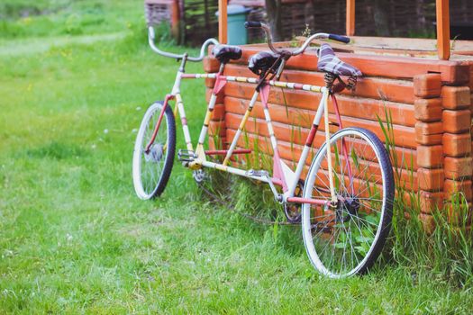 Bicycles for two passengers, the tandem on the green grass