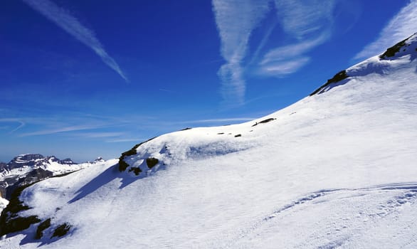 Titlis snow mountains white and vivid blue sky, Swiss