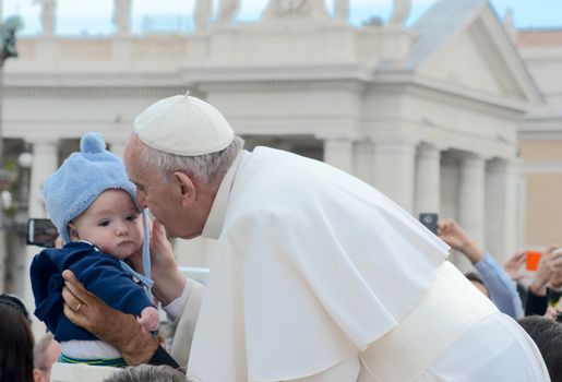 VATICAN CITY: Pope Francis kissed and held a young child, as he arrived at his general audience address in Saint Peter's Square, Vatican City on Sept. 30, 2015. Pope Francis reflected on his recent apostolic trip to Cuba and the United States. 
