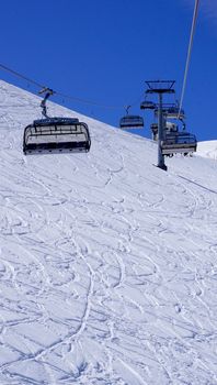 Empty ski cable car at snow mountains Titlis, Engelberg, Switzerland vertical view