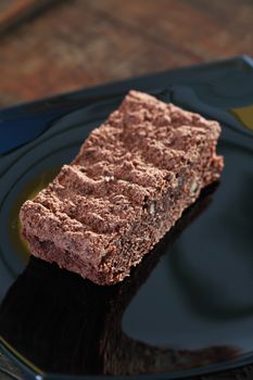 One piece of chocolate pie on black glass plate