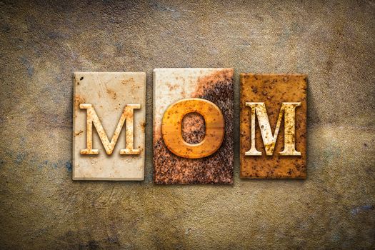 The word "MOM" written in rusty metal letterpress type on an old aged leather background.