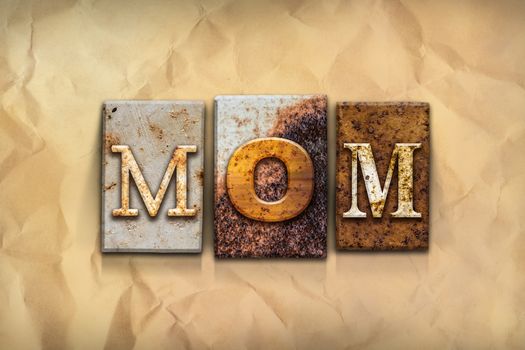 The word "MOM" written in rusty metal letterpress type on a crumbled aged paper background.