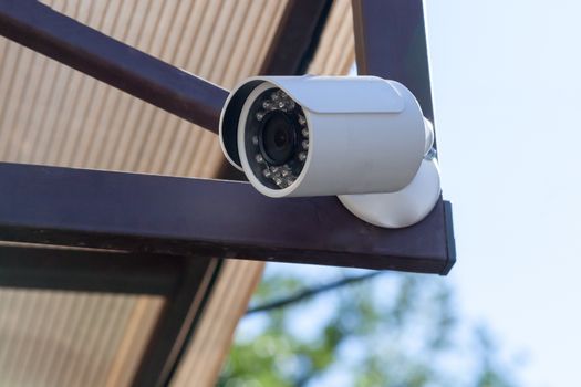 the street camera of external supervision hanging at the corner of the building