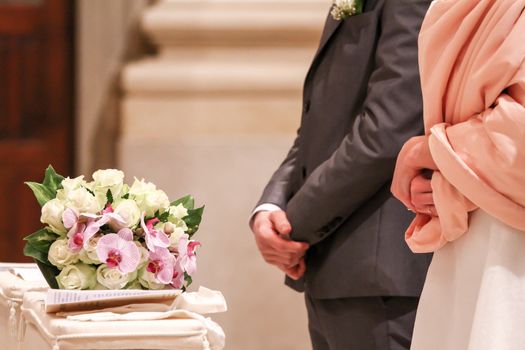 bride and groom at the altar with bouquet of flowers