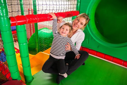 Mom and daughter in indoor playroom