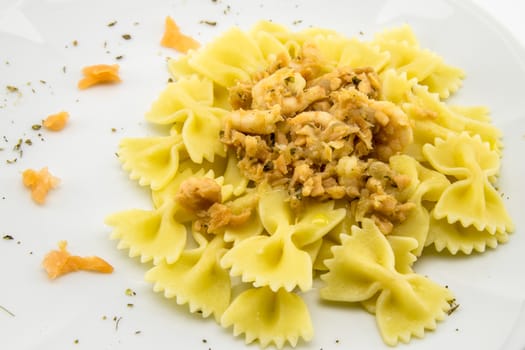 italian traditional pasta called butterflies with shrimp salmon and basil