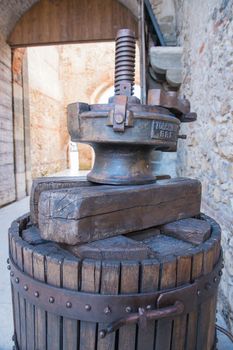 old wooden manual press used to press the grapes and make wine in Italy