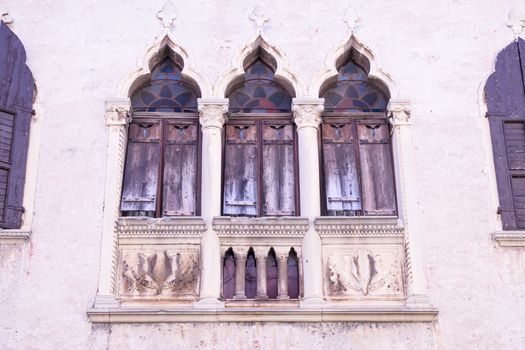 old windows on a medieval palace facade in Verona, Italy