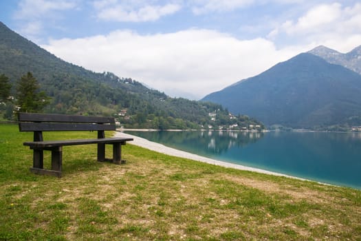 empty park bench on the lake shore