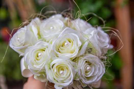 bouquet of artificial roses with white pearls