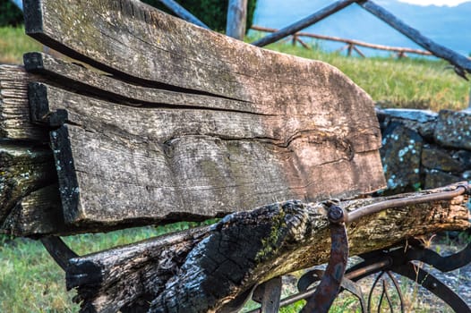 old wooden bench in a meadow