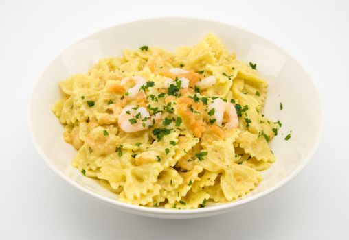 italian traditional pasta called butterflies with shrimp salmon and basil