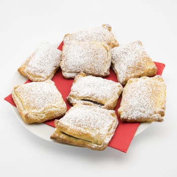 handmade biscuits of puff pastry stuffed with chocolate and covered with powdered sugar