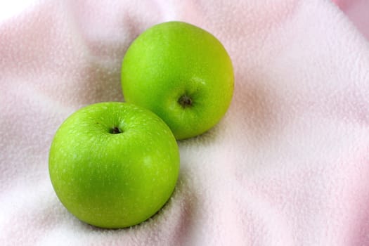 Green Apples on pink cloth