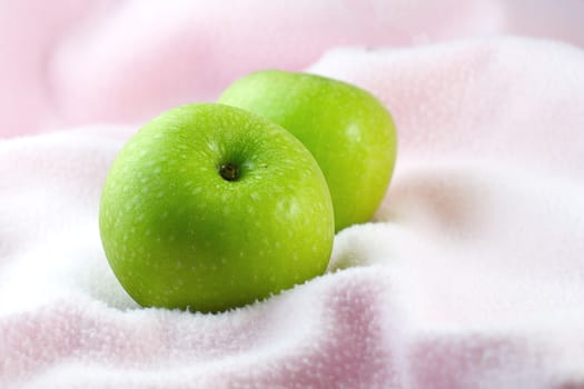 Green Apples on pink cloth