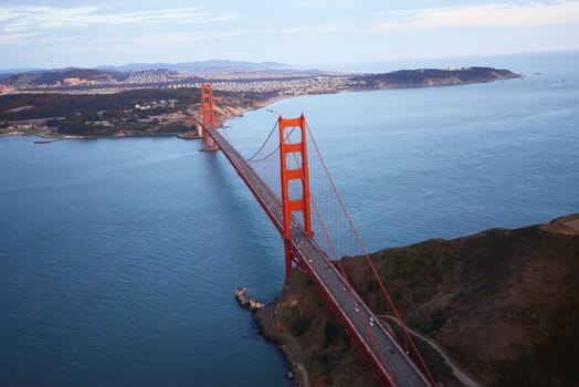 an aerial view of golden gate bridge in san francisco during sunset, taken from a helicopter