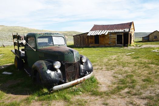 an old car in Bodie historic state park of a ghost town from a gold rush era in Sierra Nevada