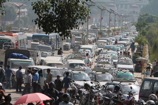 NEPAL, Kathmandu: Shortage of fuel and other supplies caused by the closure of border crossings between India and Nepal has prompted Nepalese residents to join long lines for petrol in Kathmandu, Nepal on September 30, 2015. Nepal has blamed a blockade by the Indian government for the closures, but India says the disruptions to trade are due to widespread unrest in Nepal following the enactment of its new constitution on September 20. The fuel crisis has forced the government to limit driving around Nepal, while some international airlines have cancelled flights to the country. 