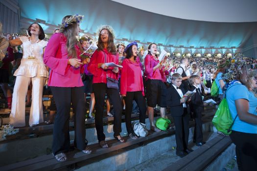 RIGA, LATVIA - JULY 10, 2010: Grand Concert of Latvian Youth Song and Dance Celebration in the Grand Stage of Mezaparks. Low light photo some digital noise present.