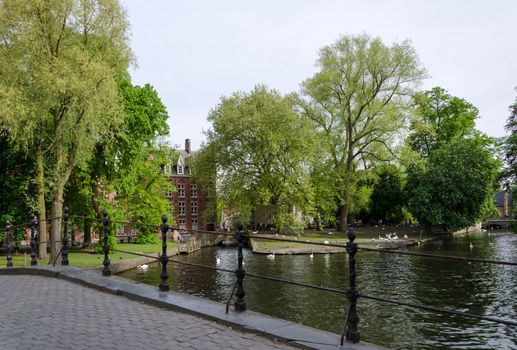 Minnewater lake in begijnhof of Bruges, Belgium