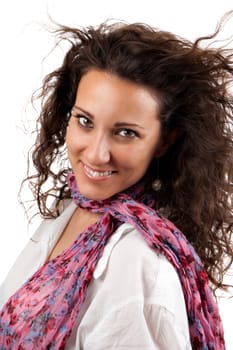 Cheerful young woman smiling with pink scarf and white background.